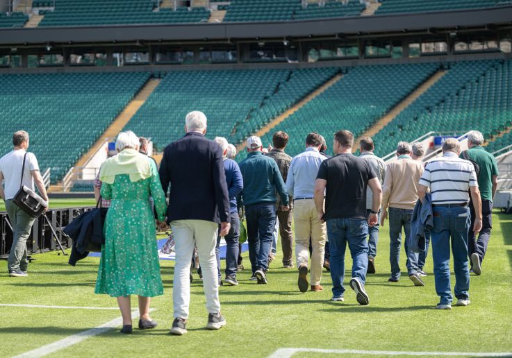 Un grupo de visitantes descubre el terreno de juego durante el tour del estadio.